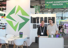 Jubao Zhang and Alex Ren of Anhui Seedlinghome Horticulture Technology. Their pots, trays and hanging baskets can be seen on the walls.
