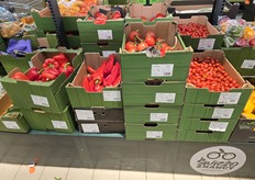 Boxed vegetables on the shelf at Biedronka, including Dutch vine tomatoes and Moroccan cherry tomatoes.