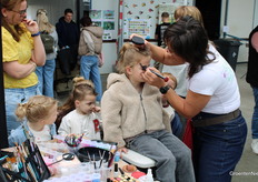 Face painting is also part of it. Will this girl be a flower?
