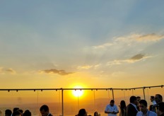 Sun sets over the post-event party