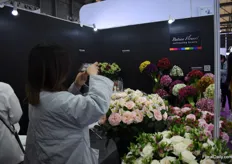 Pictures being taken at the booth of Batian Flowers.