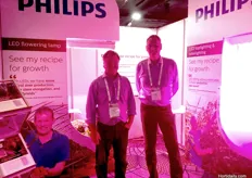 Andrew Olley and Aart Slobbe from Signify Australia standing under the bright pink LED lighting for use on a range of different crops.