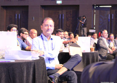 Vimal Chawda locks eyes with the camera as one session wraps up and the next speaker steps onto the stage.