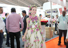 The flower girl, adorned in a gown of blossoms, was frequently stopped for quick photos.