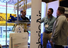 Jacob Smith and Philip Daugherty with FabricAir explaining all the ins and outs to a visitor
