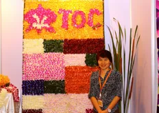 Duangporn Boonchai of Thai Orchids Co. stands before a beautiful display made with orchids.