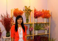 Miss Weevaya presenting a variety of orchids of Sun International Flower.