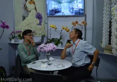 Ivan Liao from Royal Base Corporation talking with a visitor.