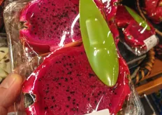 Sliced dragon fruit with a spoon.