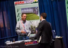 Jim Bergantz of AgraTech Greenhouse Manufacturing welcomes a visitor at his booth.