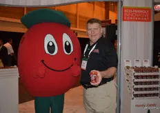A happy tomato mascot and Michael Prather with Handy Candy, proudly showing the company's tomato cups.