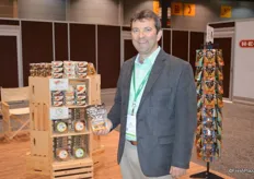 Mike DeCramer with Truly Good Foods has a lot of products on display and proudly shows Praline Pecans.