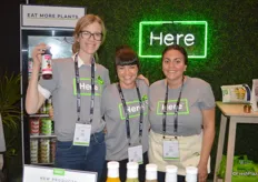 The ladies from HERE proudly show their cold-pressed juices, dips, spreads and salad dressings. They are all plant-based and made with Midwestern local produce. From left to right: Megan Klein, Anne Owen and Neveen Elias.