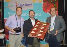 Nick Wishnatzki, Marcus Caswell and James Peterson with Wish Farms proudly show a flat of strawberries and a 32 oz. clamshell of blueberries.