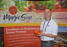 Tony Otto with MagicSun proudly shows tomatoes on the vine.
