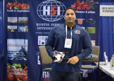 Randor Cena of HSI holding a semi automatic labeling machine