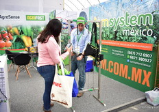 Juan Pablo Saucedo of AgroSense showing a visitor how to use TomSystem and how it saves labor as it clips 1,600 tomato plants per hour. It is on the Mexican market for about 8 years and over the last three years, he has seen the demand growing for this product. 