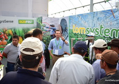 Juan Pablo Saucedo of AgroSense explaining the Tomsystem to a group of visitors.