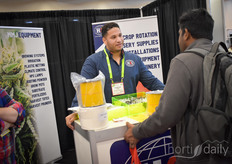 Randor Cena with HSI (Hortus Supplies International) talks to a visitor about their supplies for the vegetable, floral and MMJ market.