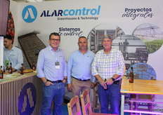 Juan López and Antonio Escudero, accompanied by a customer, at the Alarcontrol stand.