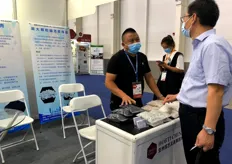 Wu Wenqiang, the person in charge of Xinyang Yonghao Business Co., Ltd., is introducing the company's products to visitors. The company's main products include perlite, expanded products, glazed hollow beads and other products.